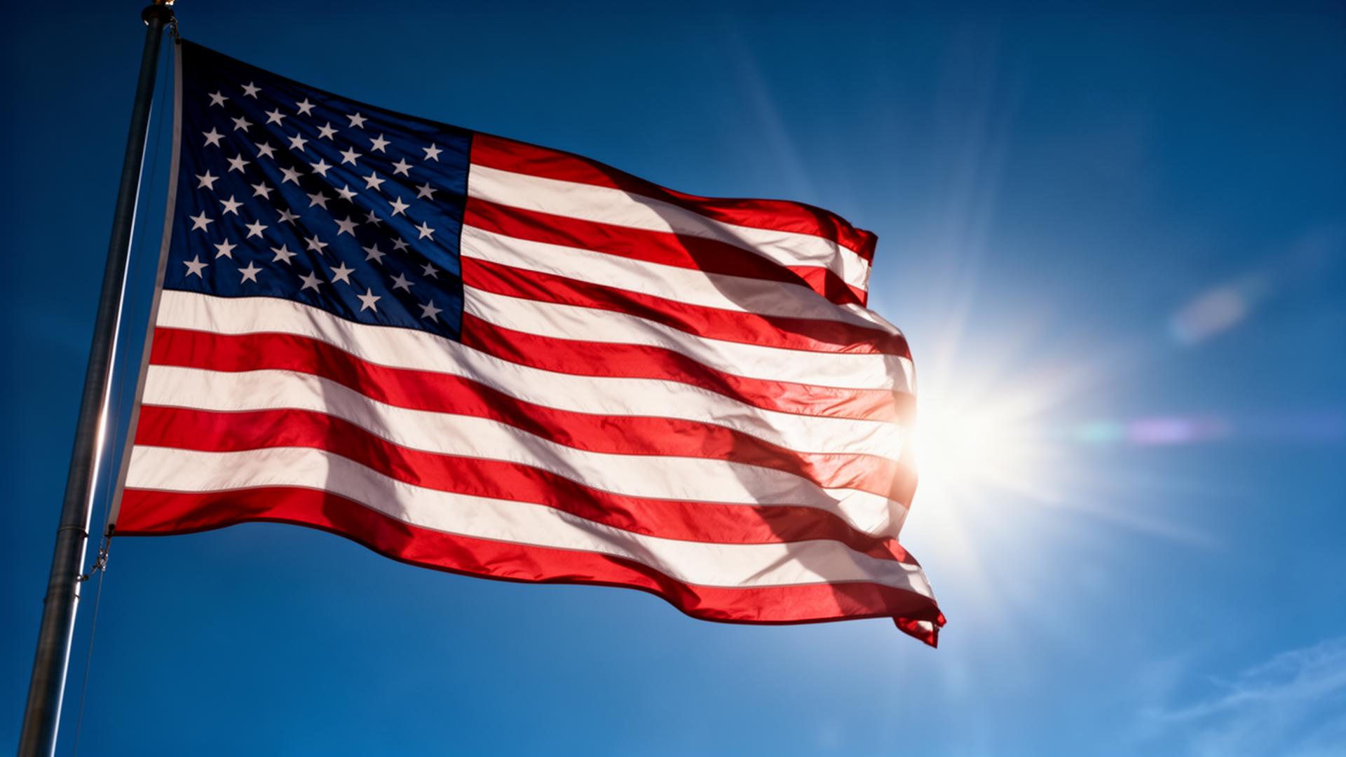 American flag waving against a blue sky